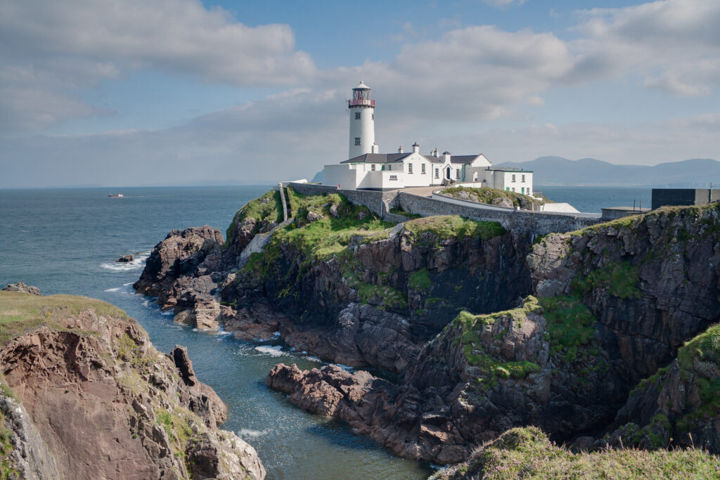 Fanad Head Lighthouse, a white tower and keeper's cottages on the cliffs of the Fanad Peninsula, County Donegal