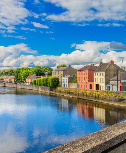 Colourful buildings along a river in an Irish town, Ireland