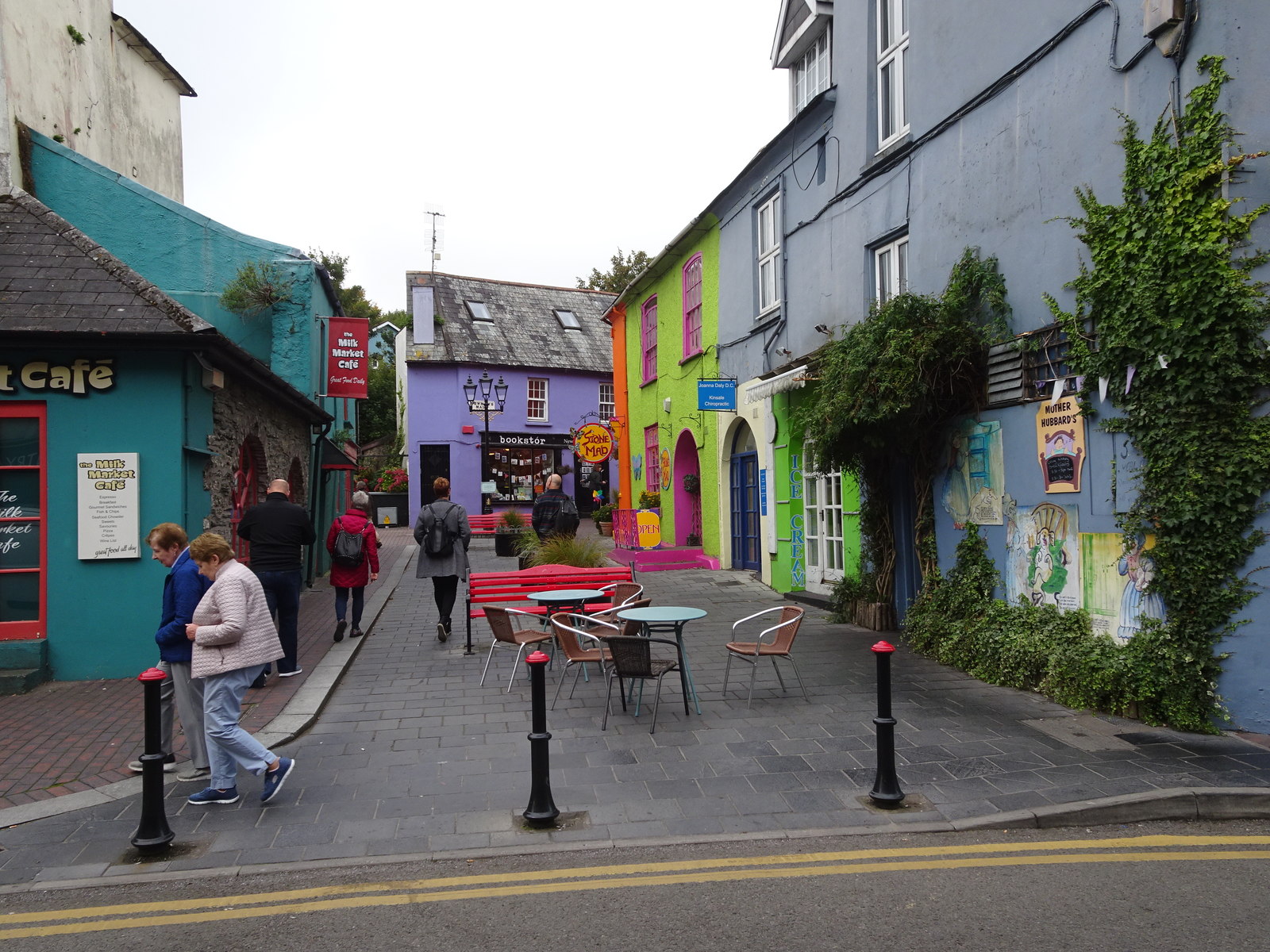 Colourful painted shopfronts and cafés on a pedestrian street in Kinsale, County Cork