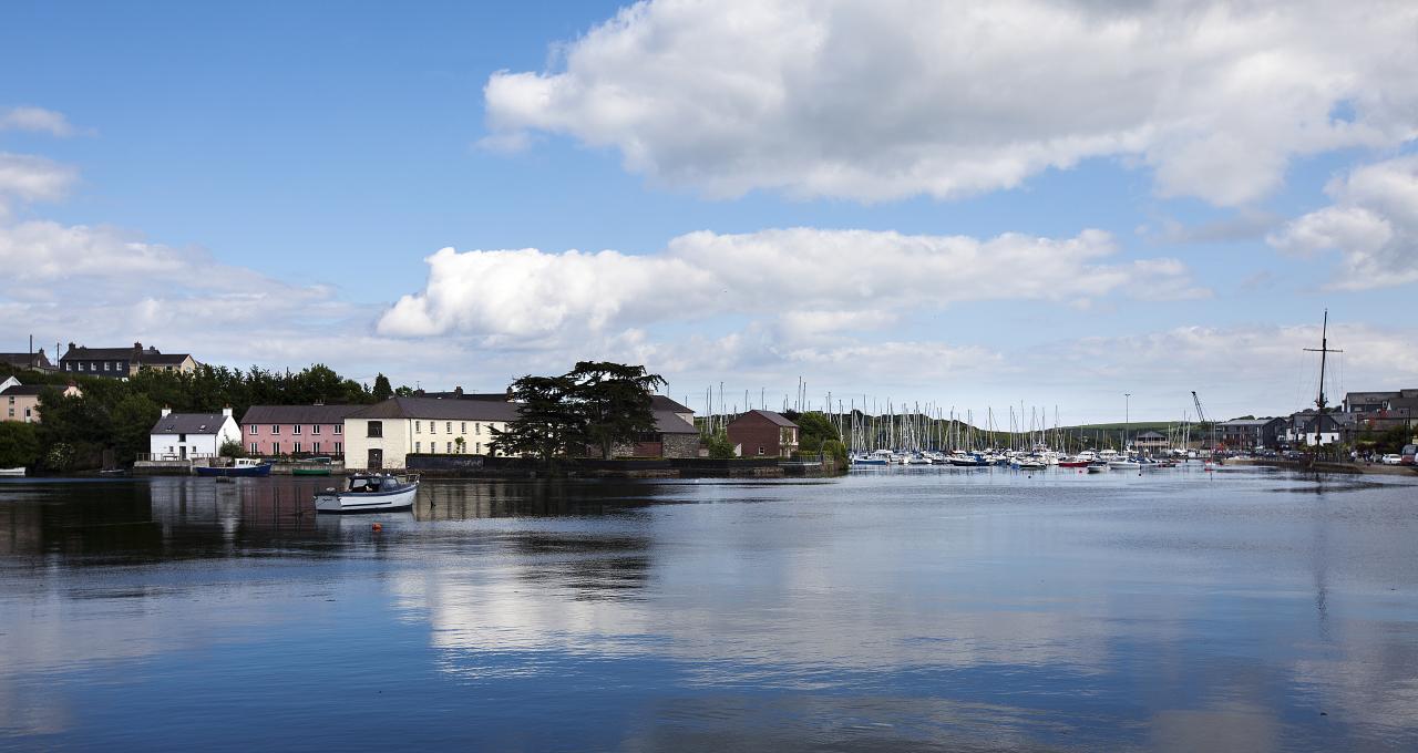 Kinsale harbour in West Cork, with pastel-coloured waterfront houses and yachts moored along the marina