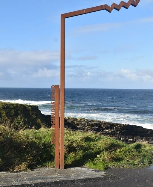 The Mullaghmore Head trail marker overlooking the Atlantic coastline on a calm day, County Sligo, on the Wild Atlantic Way