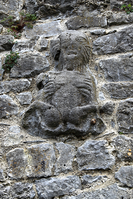 Weathered Sheela-na-gig figure carved into the medieval town wall at Fethard, County Tipperary, Ireland