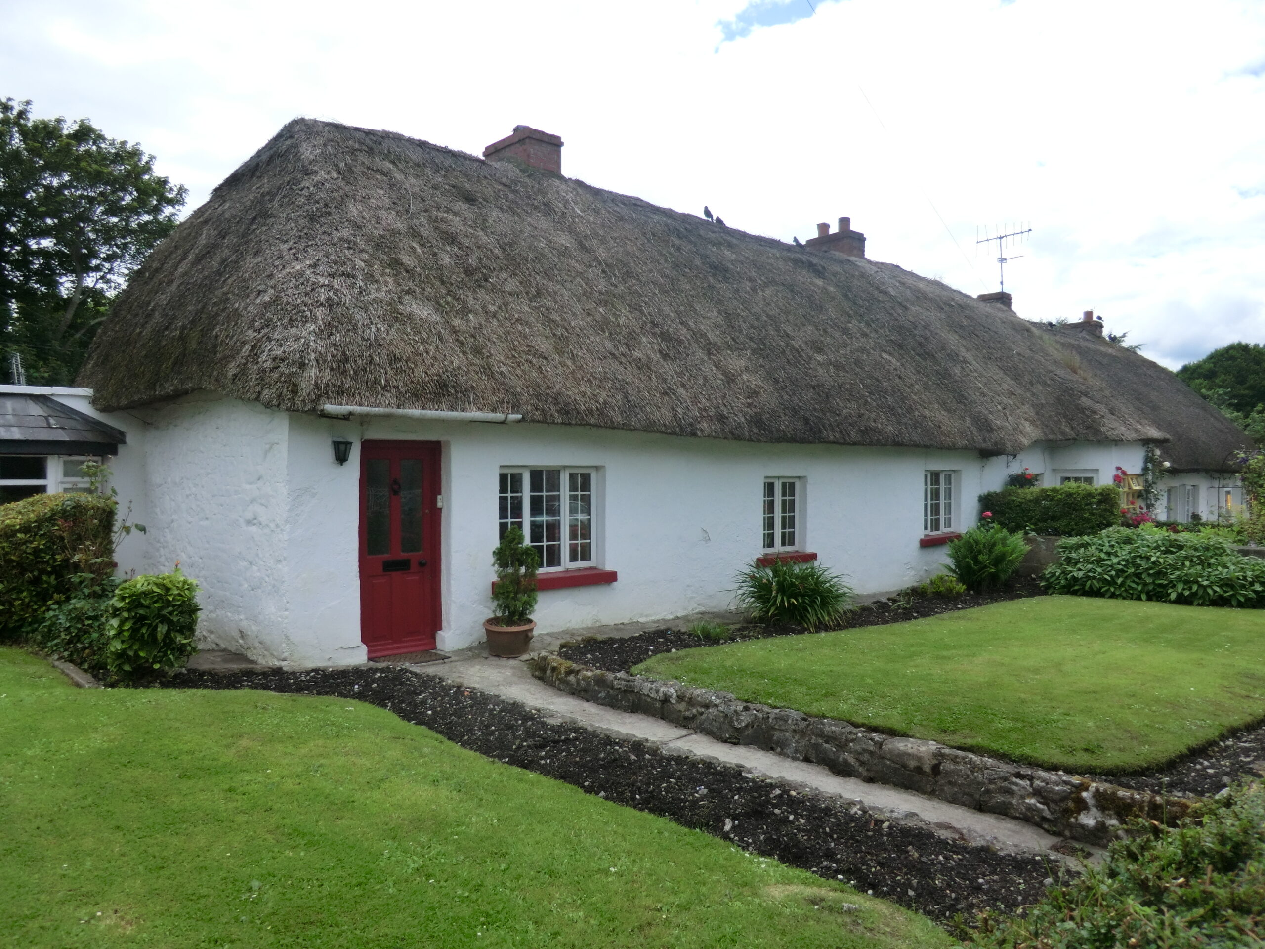 Thatched-roof cottage on the main street of Adare village, County Limerick, Ireland