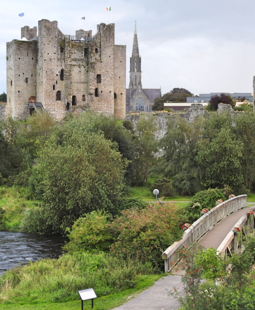 Medieval castle ruins beside an Irish river, Cromwellian era Ireland