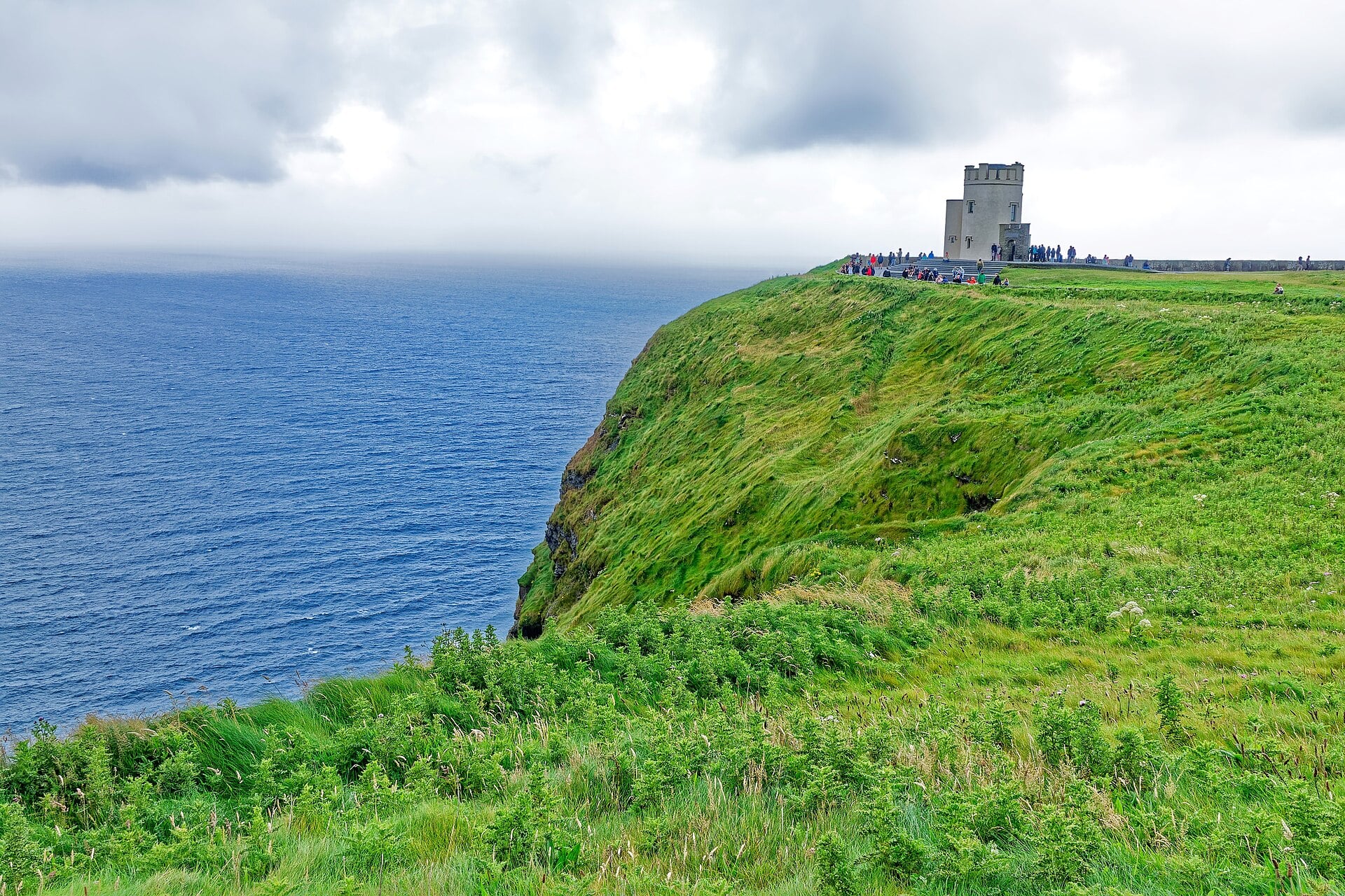 Cliffs of Moher rising above the Atlantic Ocean with O'Brien's Tower on the clifftop, County Clare, Ireland