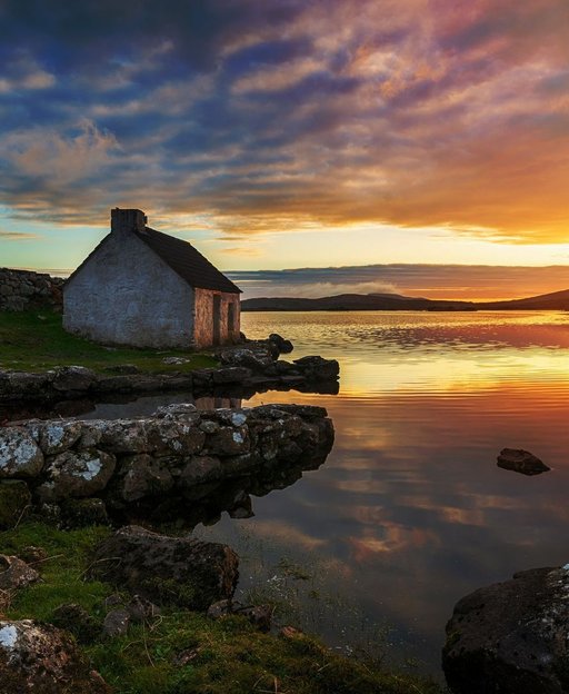 Old fisherman cottage at sunset on the Connemara coast, County Galway, Ireland