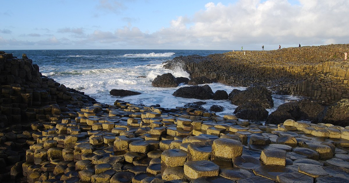 Waves crash over the hexagonal basalt columns at the Giant's Causeway, County Antrim
