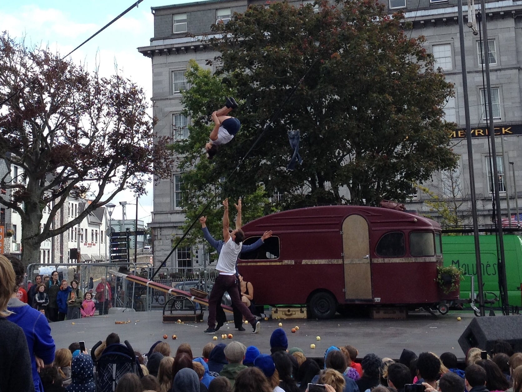 Street performers doing acrobatics for crowds at the Galway International Arts Festival