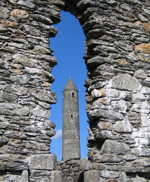 Glendalough Round Tower viewed through stone ruins, County Wicklow, Ireland