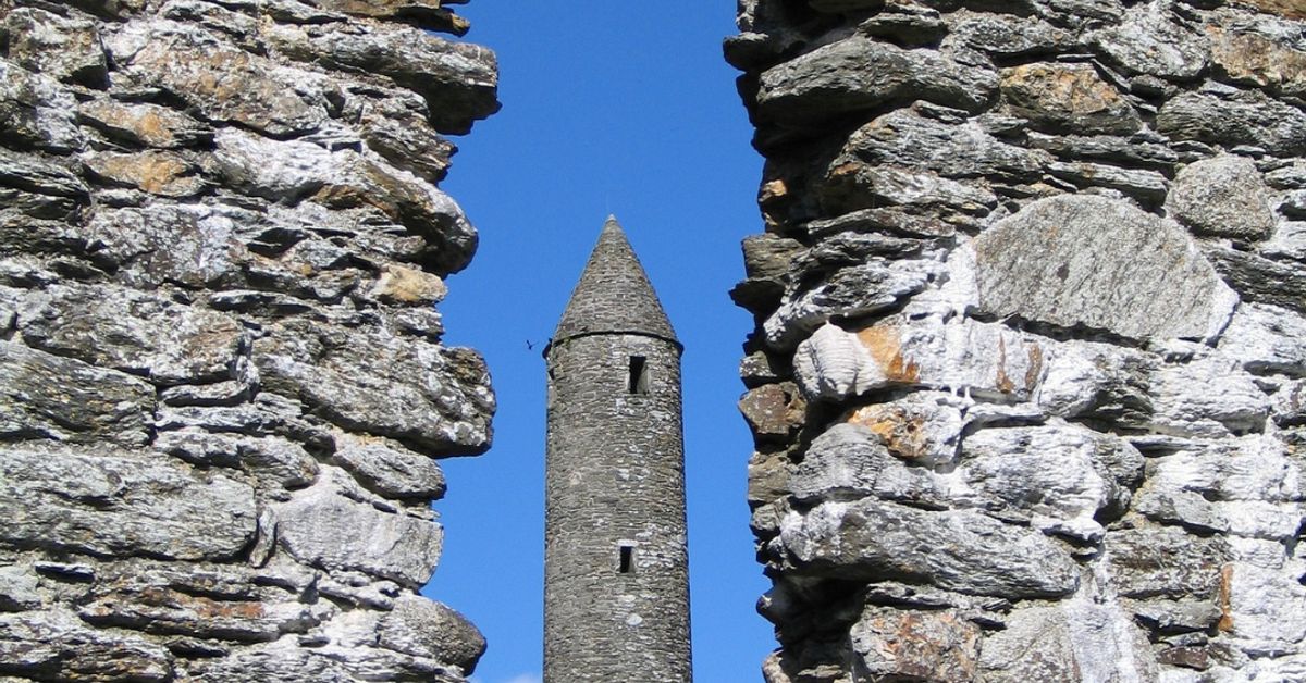 Glendalough Round Tower viewed through stone ruins, County Wicklow, Ireland