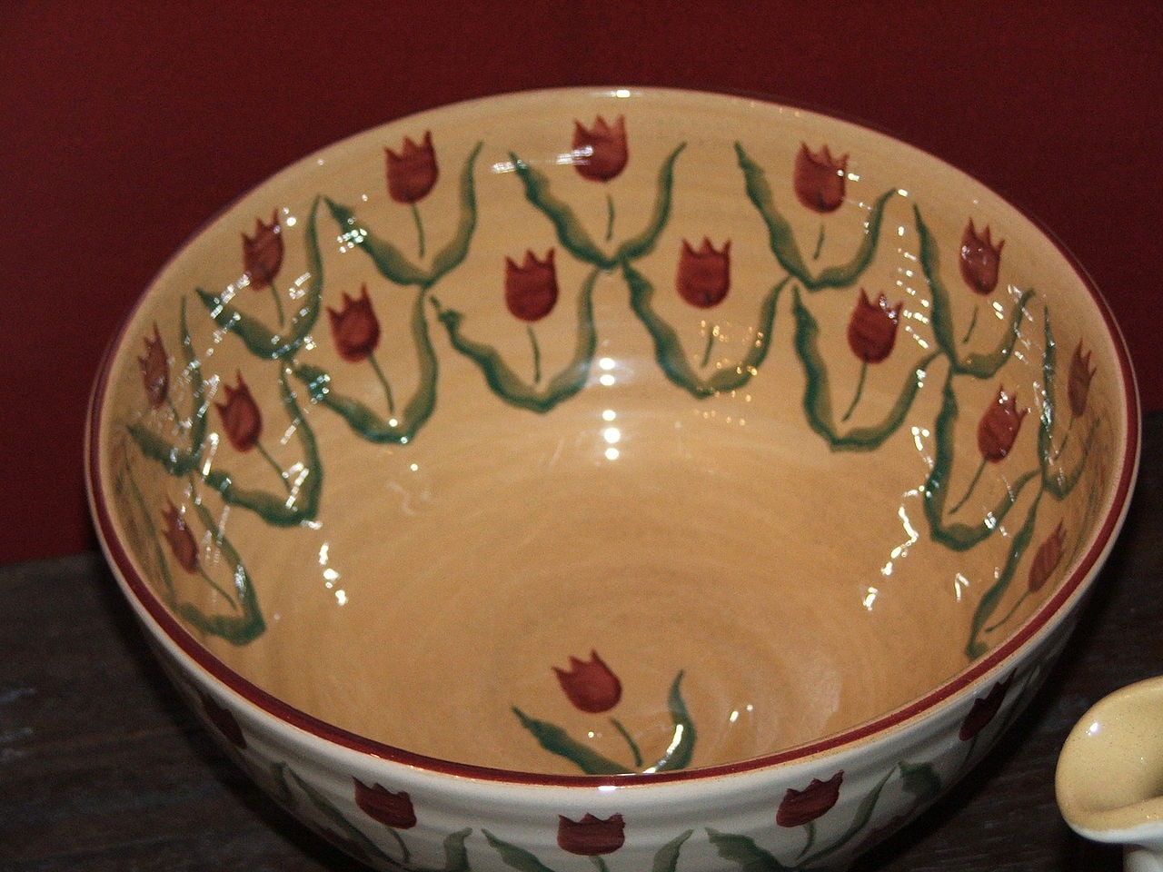 Hand-painted Irish ceramic bowl with a tulip motif, an example of traditional Irish pottery craft