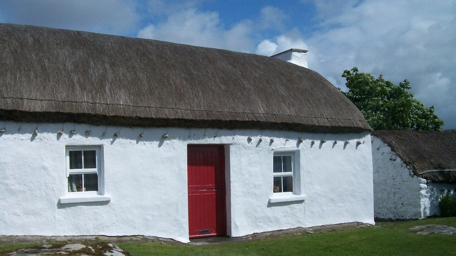 A traditional whitewashed thatched Irish cottage, the kind of home where a wake would once have been held