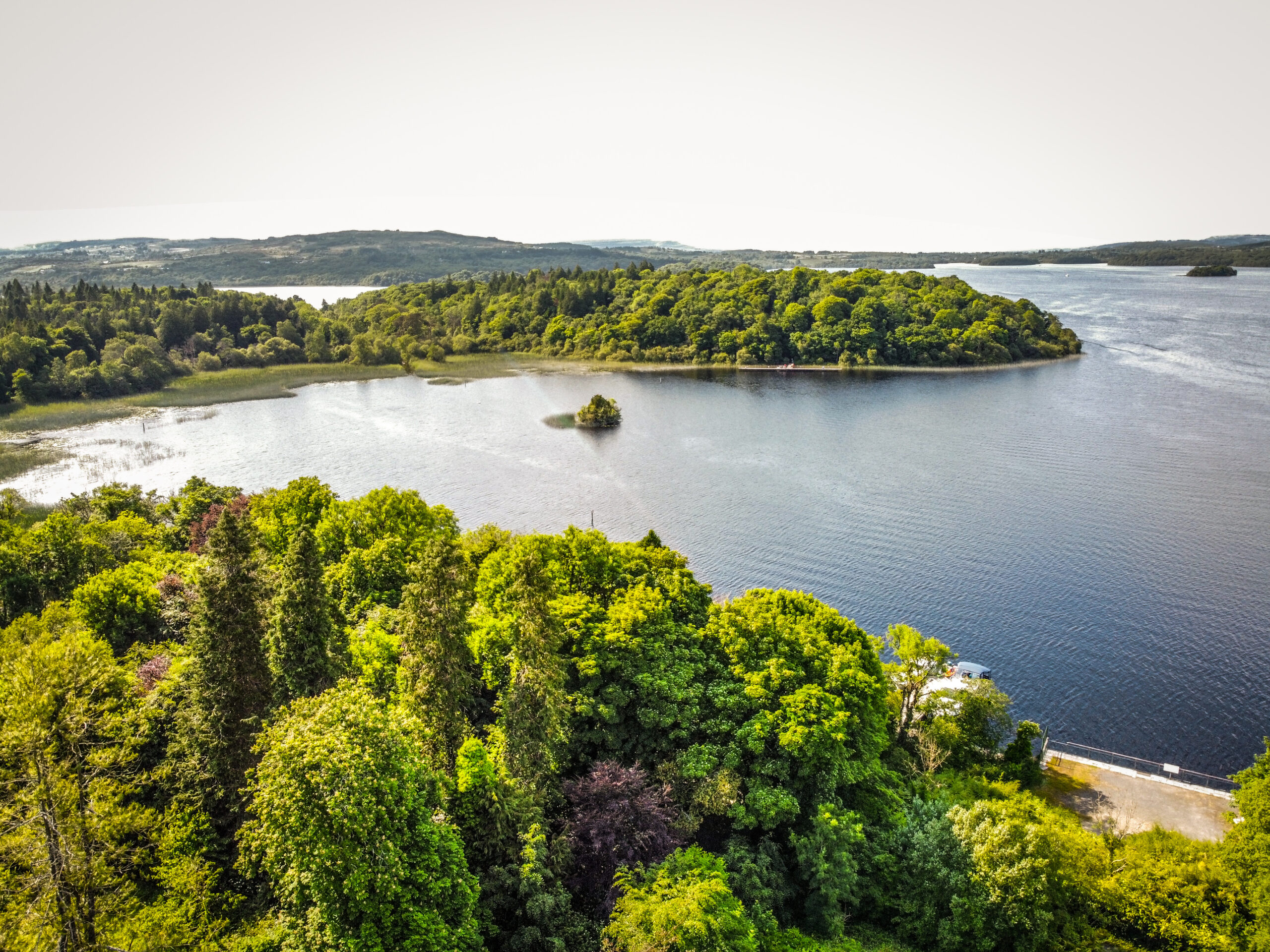 Aerial view of Lough Key Forest Park's lake, wooded shoreline and small island, County Roscommon, Ireland