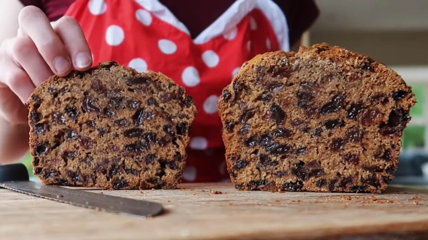 Slice of dense, dark Irish fruit cake studded with plump dried fruit and a rich moist crumb