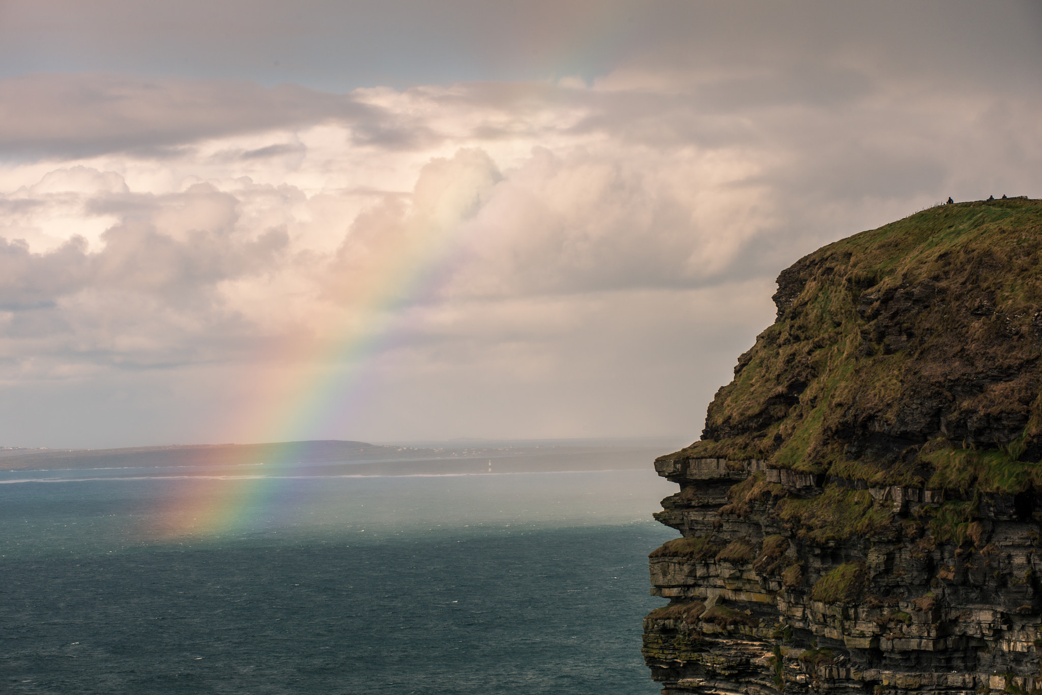 Rainbow arching over the Cliffs of Moher and the Atlantic coastline, County Clare, Ireland