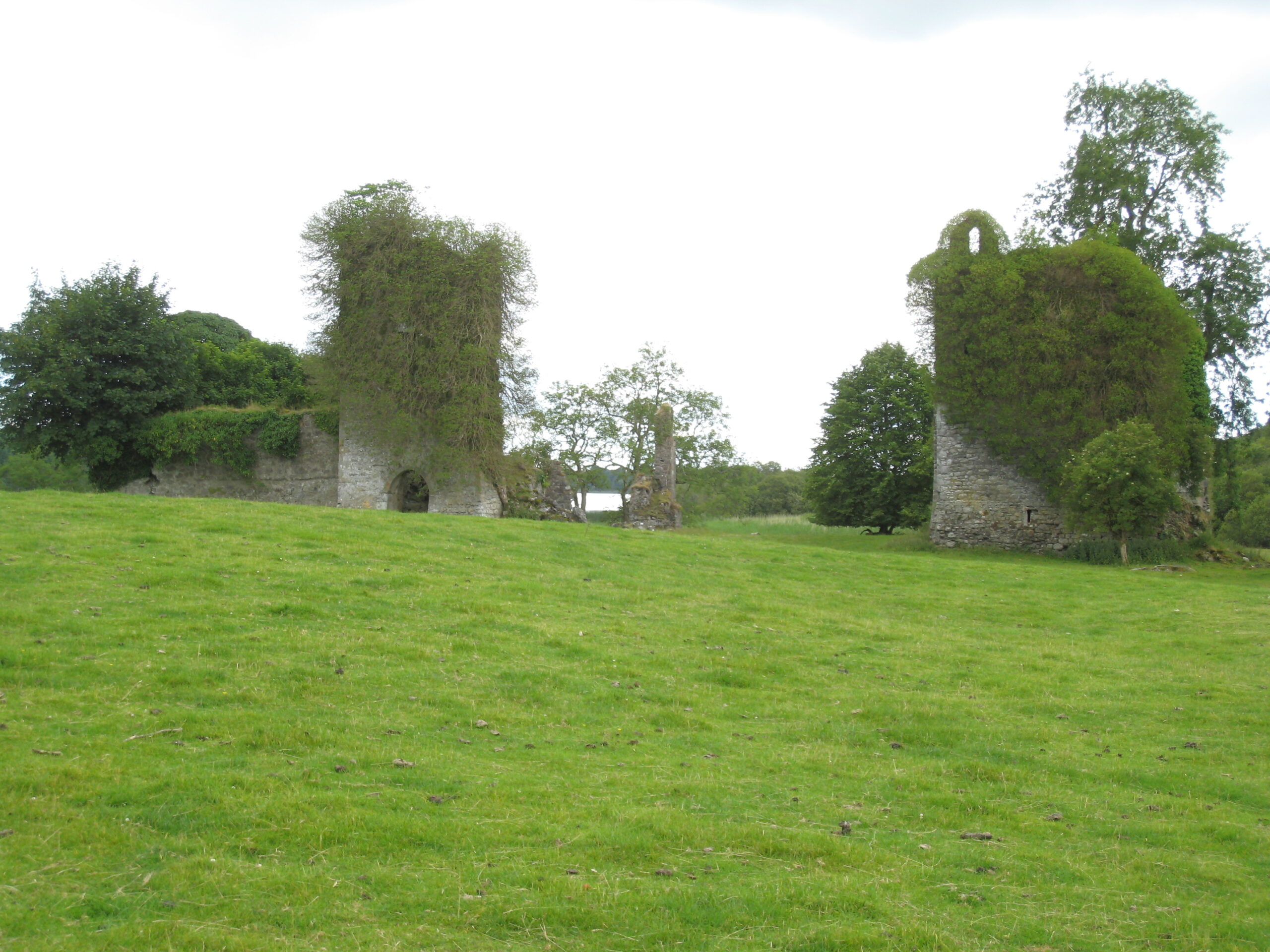Ivy-covered ruins of the 12th-century Knights Templar castle beside the lake at Temple House, County Sligo