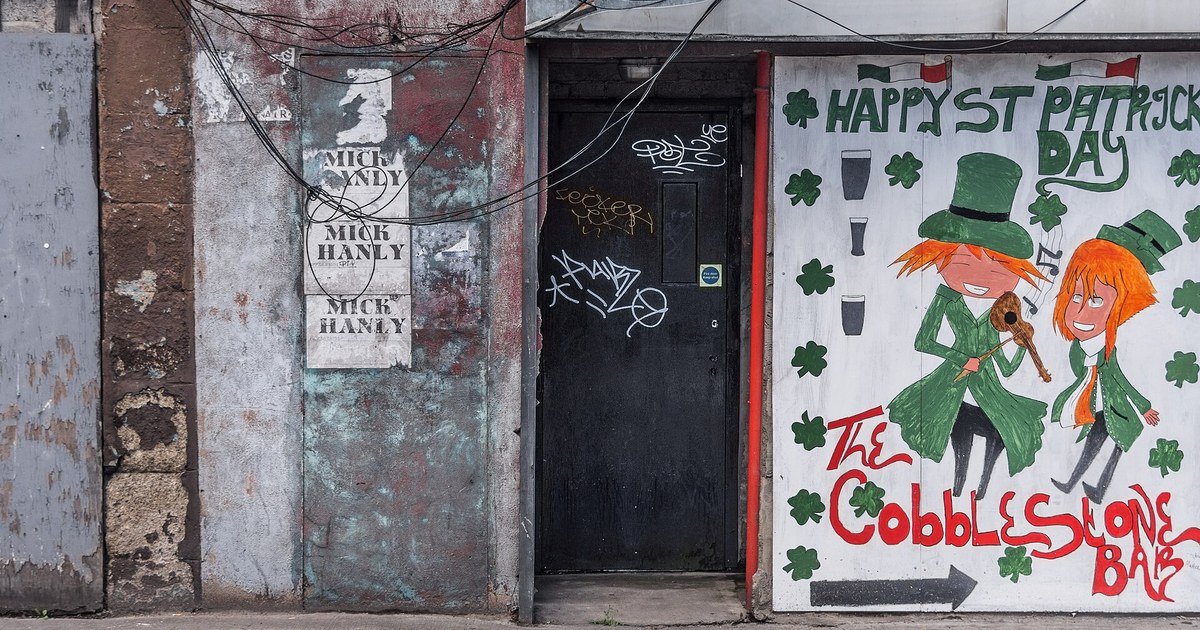 Hand-painted St Patrick's Day mural and gig posters on the exterior wall of The Cobblestone pub in Smithfield, Dublin