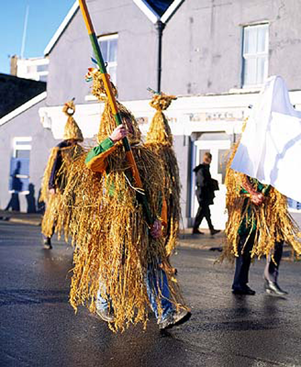 Wren Boys in traditional straw suits parading through Dingle, County Kerry on St Stephen's Day