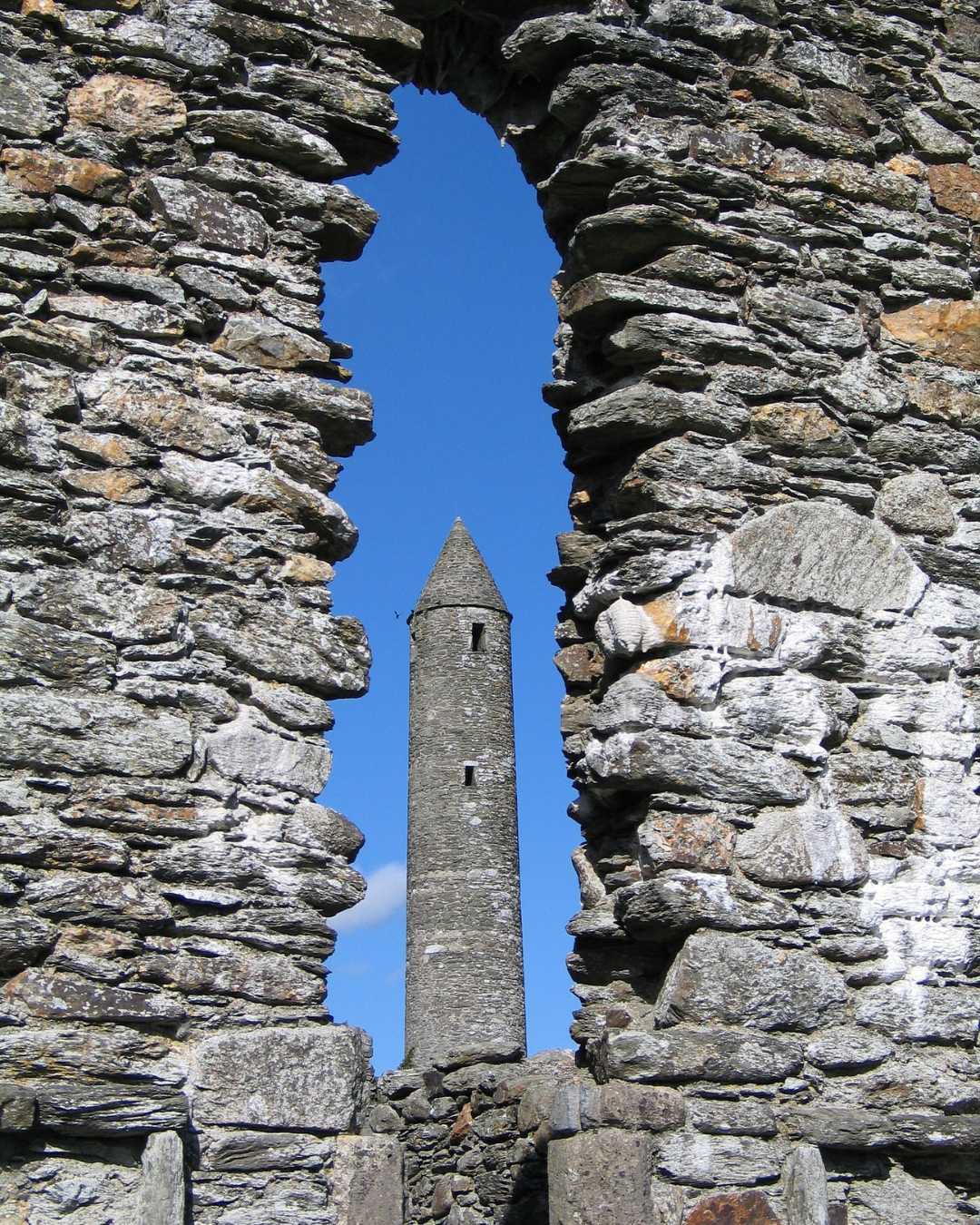 Glendalough round tower rising against an Irish sky, a symbol of ancient Gaelic civilisation and Brehon Law era Ireland