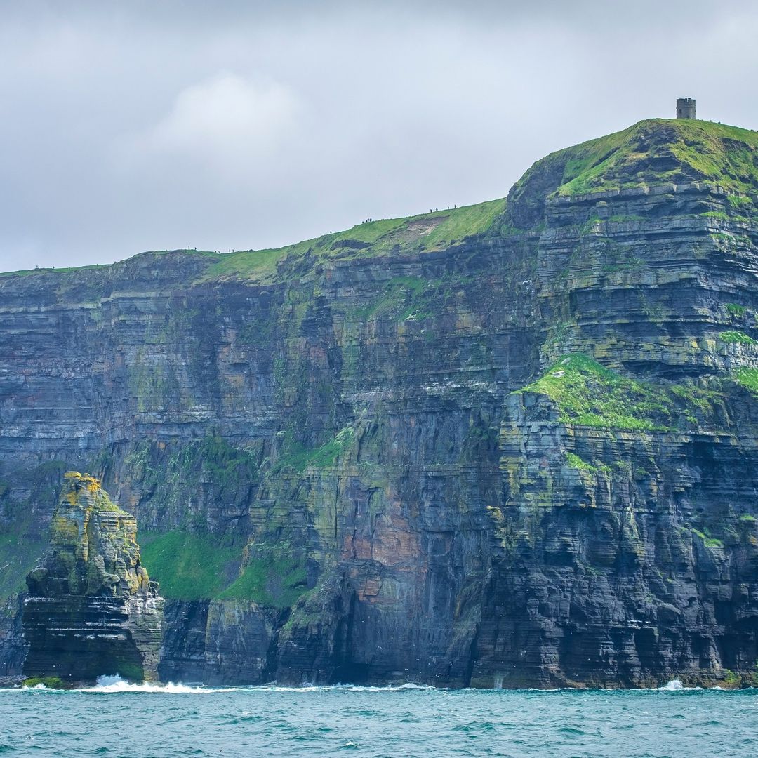 Dramatic Irish coastal cliffs rising from the Atlantic Ocean &mdash; the domain of Manann&aacute;n mac Lir, the Irish sea god