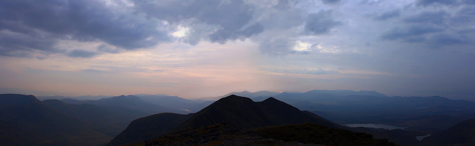 Silhouetted peaks of the MacGillycuddy's Reeks mountain range at dusk