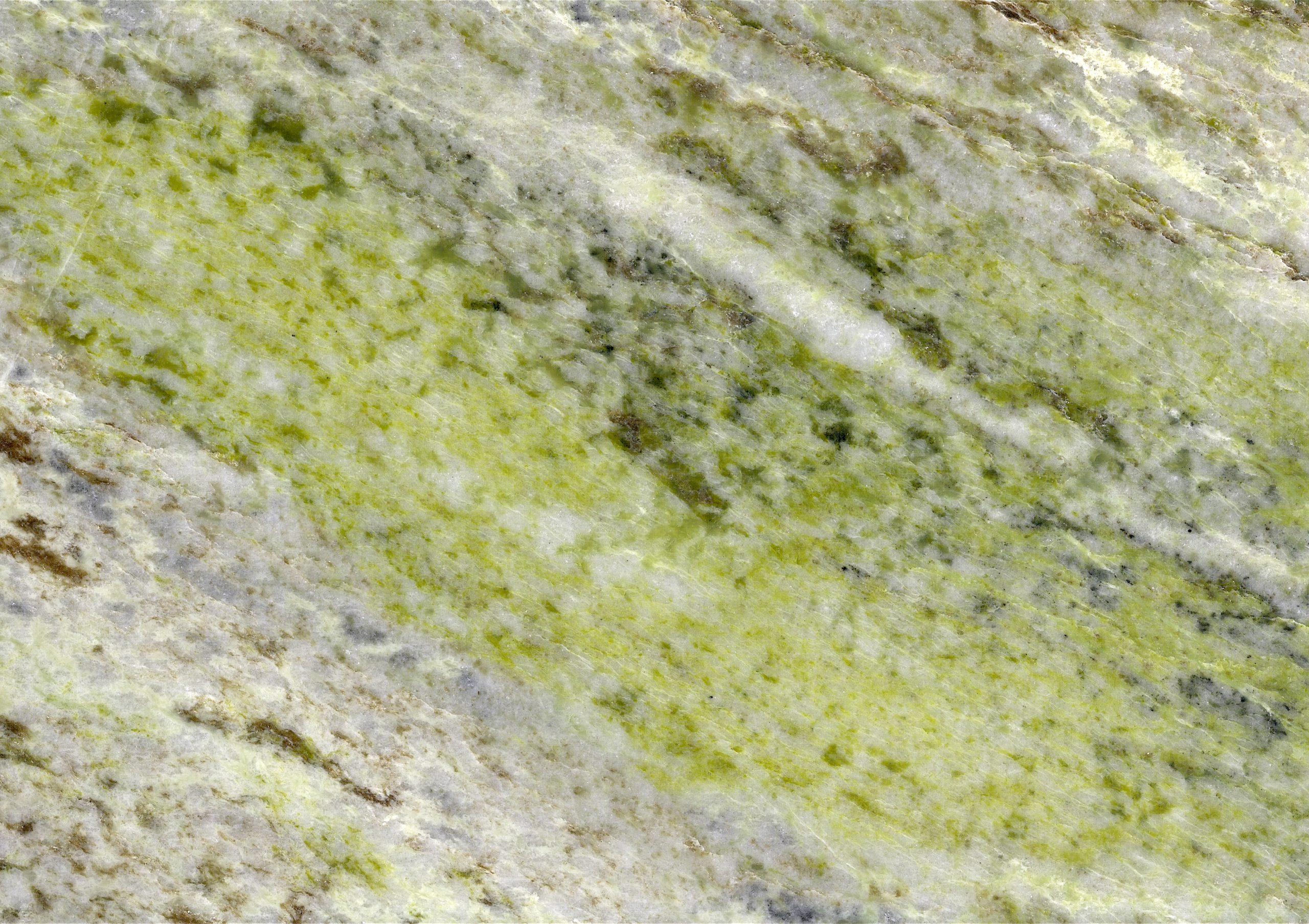 Close-up of Connemara marble showing its jewel-green serpentine veining through white calcite and grey limestone