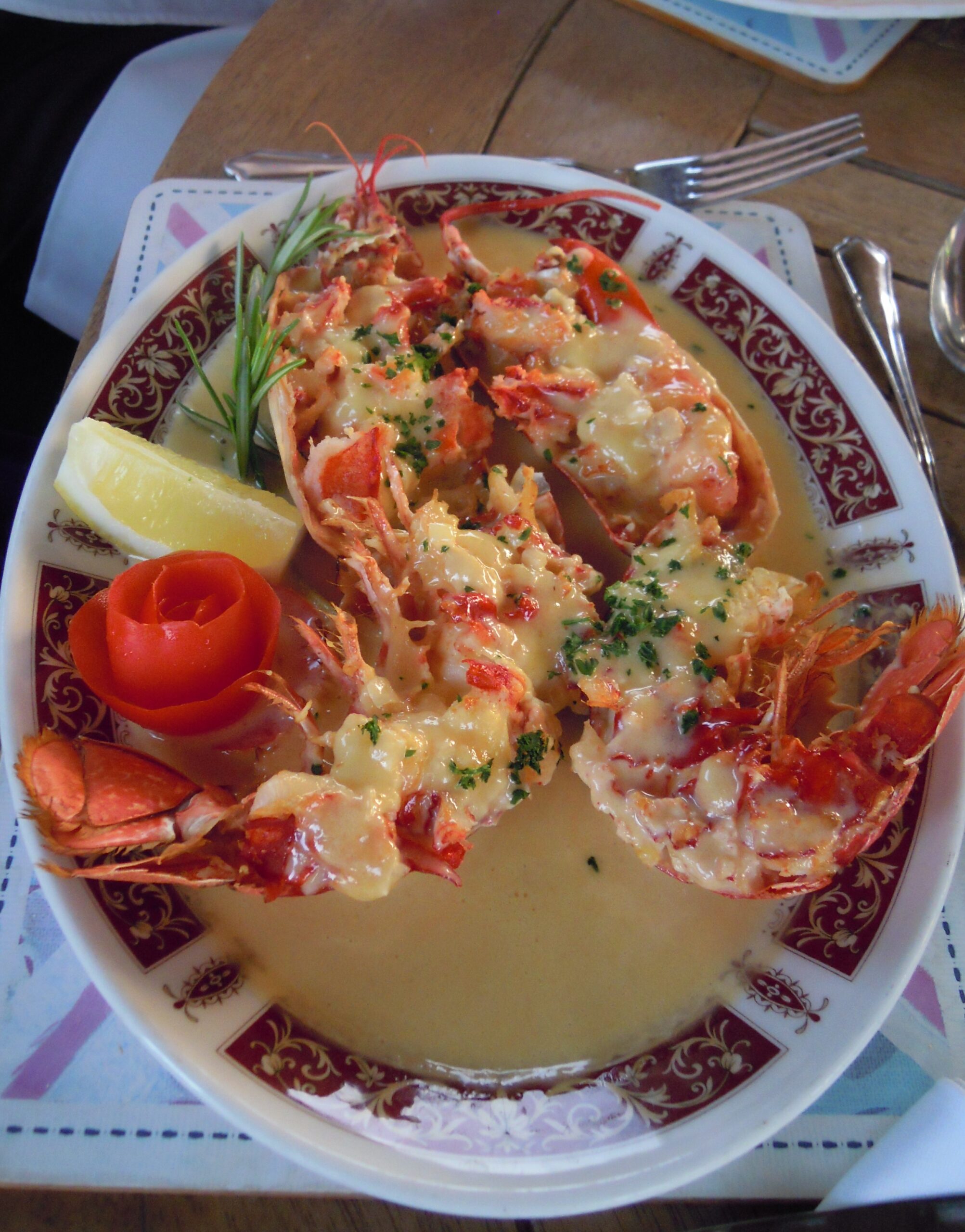Split lobster halves in a rich cream sauce on a plate, similar to Dublin Lawyer