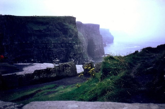 Fog and mist clinging to the cliff face at the Cliffs of Moher, County Clare, obscuring the view along the coastline