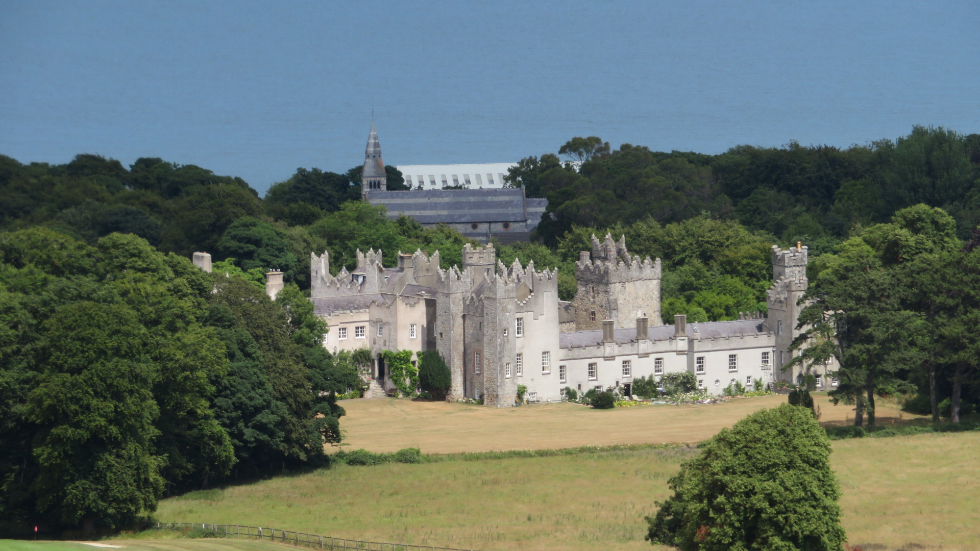 Howth Castle, the ancestral home of the Gaisford-St Lawrence family, viewed from a rocky outcrop on Howth Hill with Dublin Bay behind