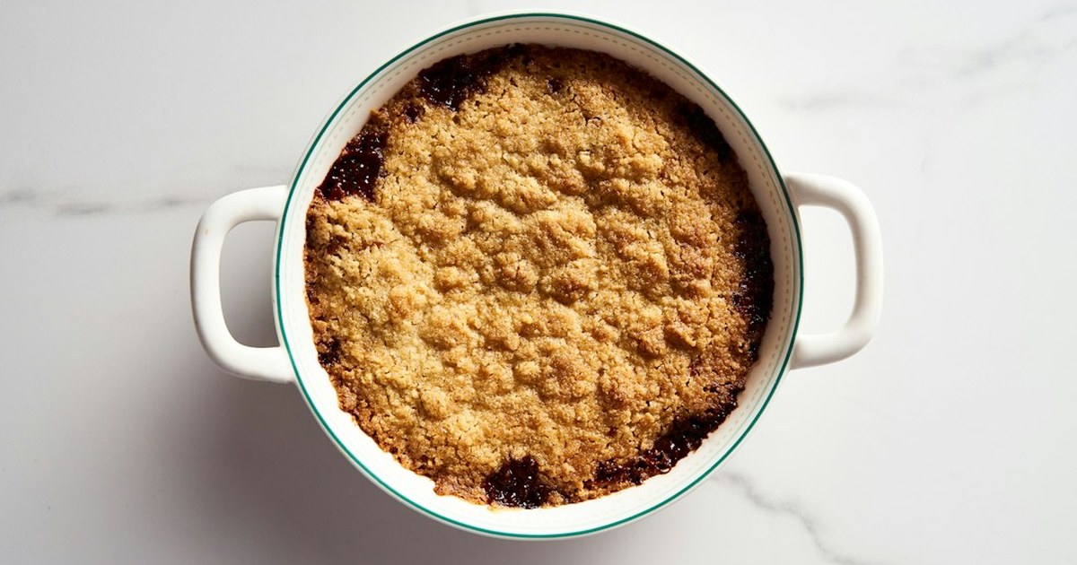Golden-baked Irish apple and blackberry crumble in a white ceramic dish, fresh from the oven
