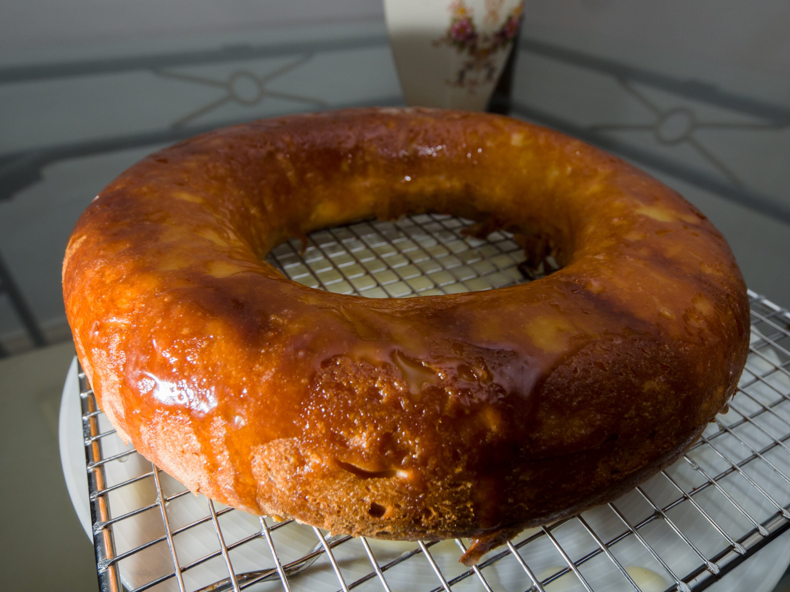Golden Irish whiskey cake soaked in whiskey syrup, cooling on a wire rack