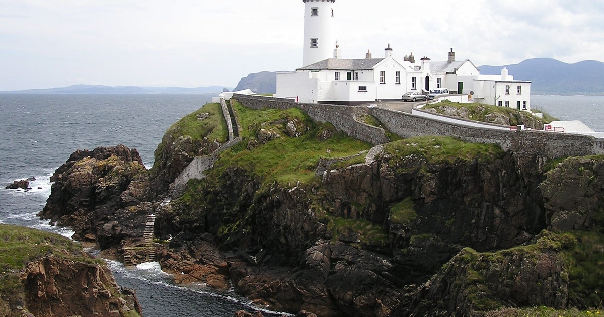 Fanad Head Lighthouse and its restored keeper's cottages on the cliffs above Lough Swilly, County Donegal