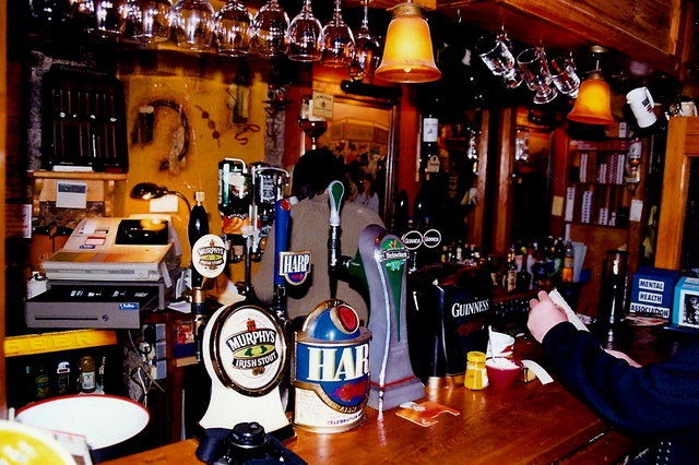 The bar counter at a traditional pub in Listowel, County Kerry, Ireland, with taps for Guinness, Murphy's Irish Stout, and Harp lager