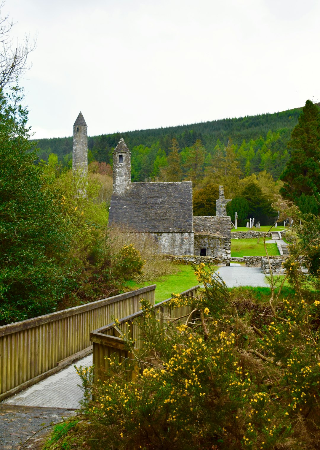 Early medieval stone church and round tower at Glendalough, County Wicklow, seen from a wooden walkway