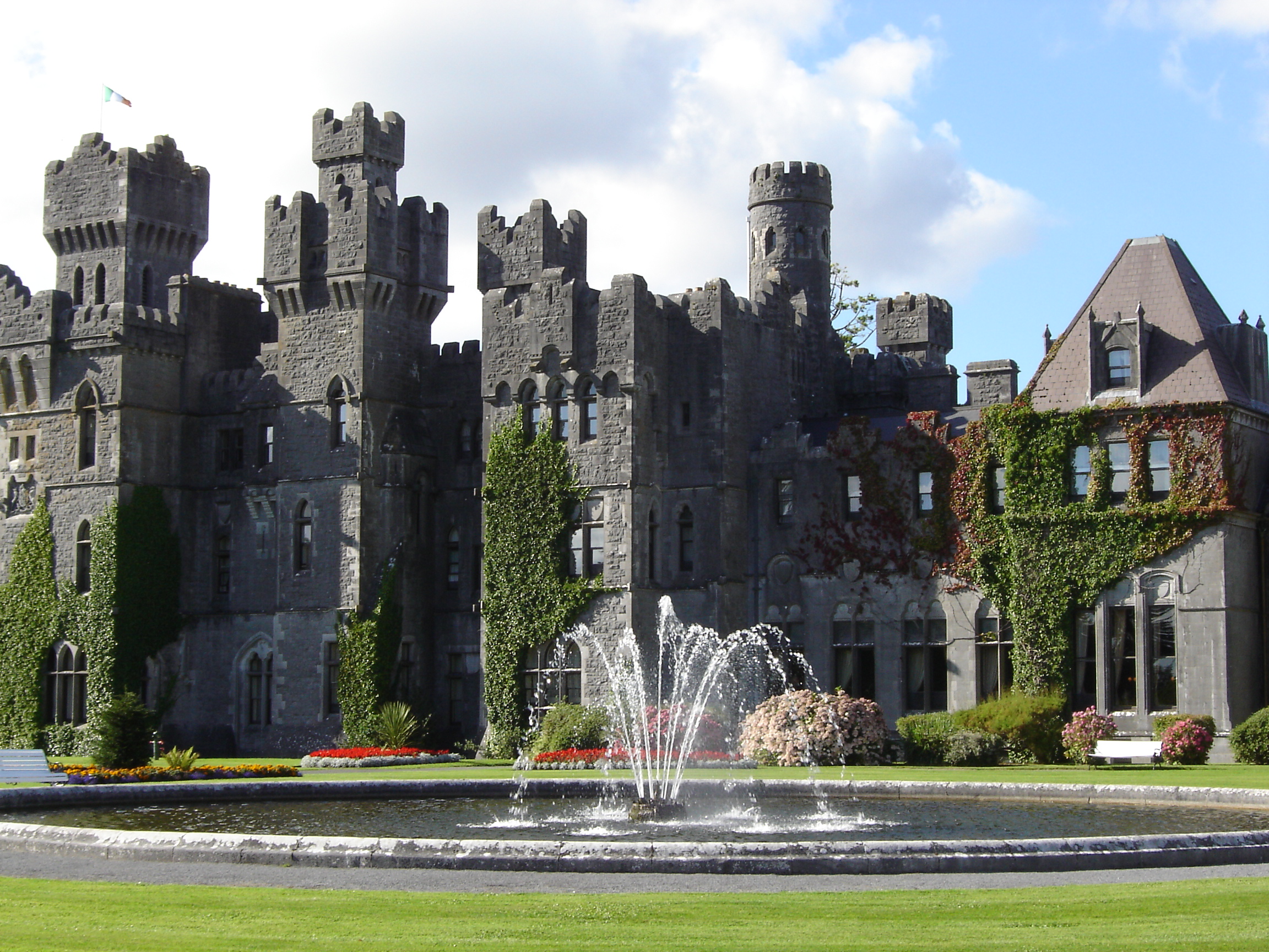 Ashford Castle, County Mayo, a historic turreted castle hotel with gardens and a fountain, a popular autumn stay in Ireland