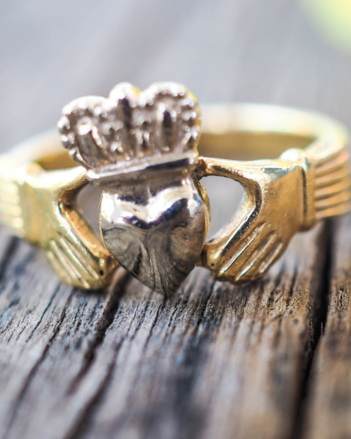 Gold Claddagh ring showing two hands holding a crowned heart