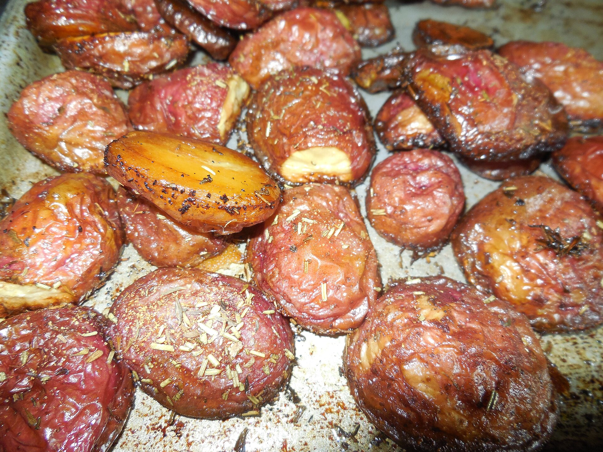 Crushed Golden Wonder potatoes roasted until deeply golden and crisp at the edges, scattered with herbs