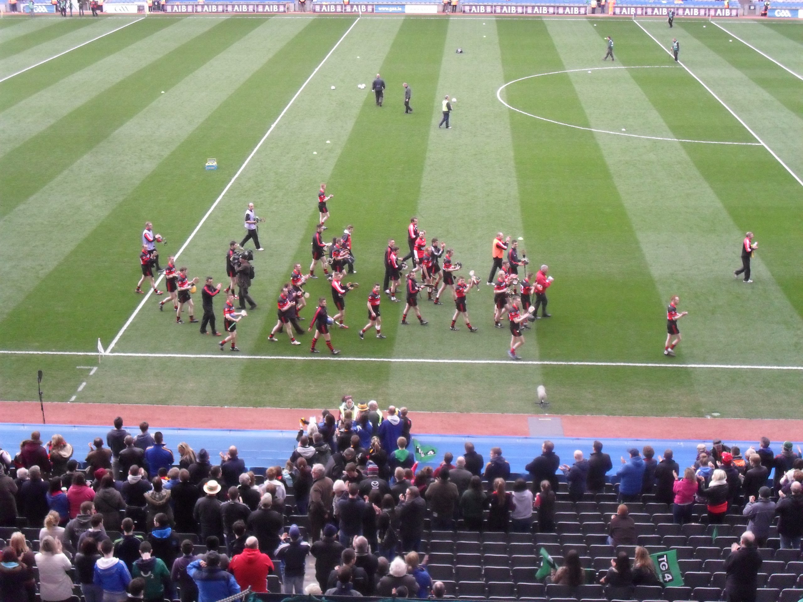 Hurlers warming up on the pitch at Croke Park ahead of a GAA match