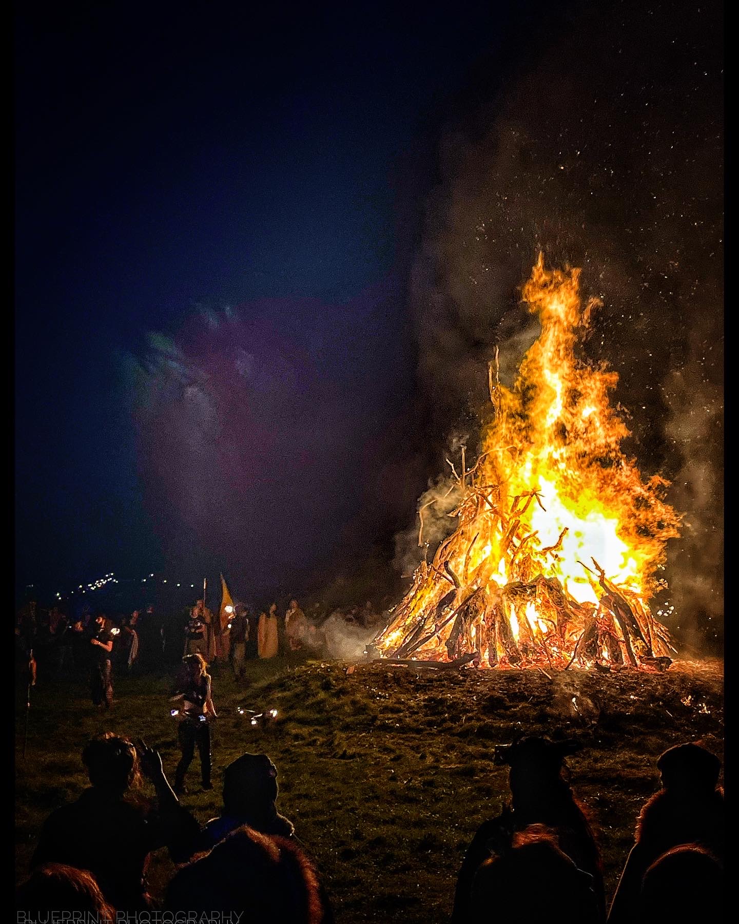 Crowd gathers around a blazing bonfire at a Celtic fire festival in Ireland, echoing the ancient Samhain fires once lit in County Meath