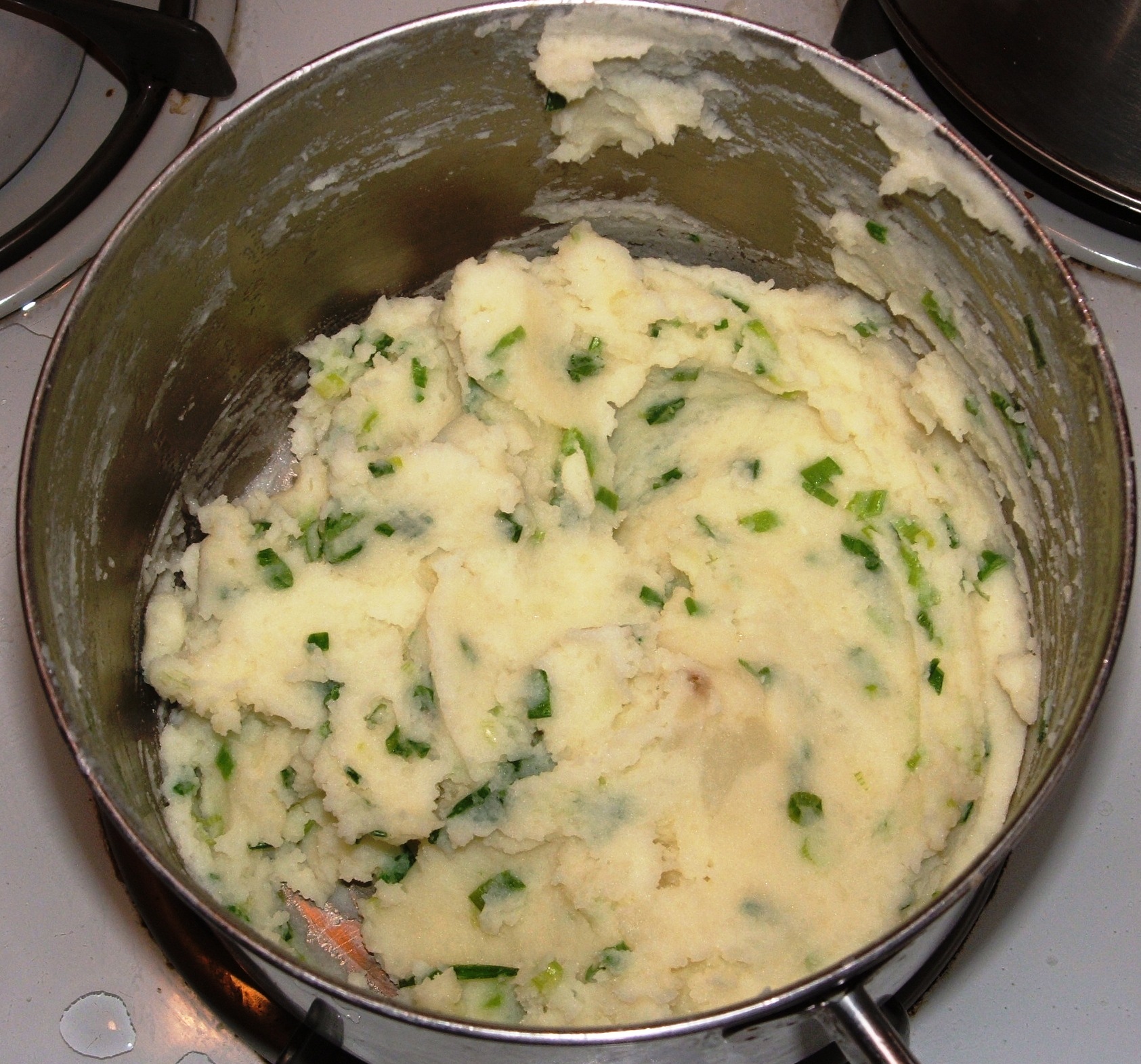 Pot of Irish champ, mashed potato mixed with chopped spring onions and melted butter