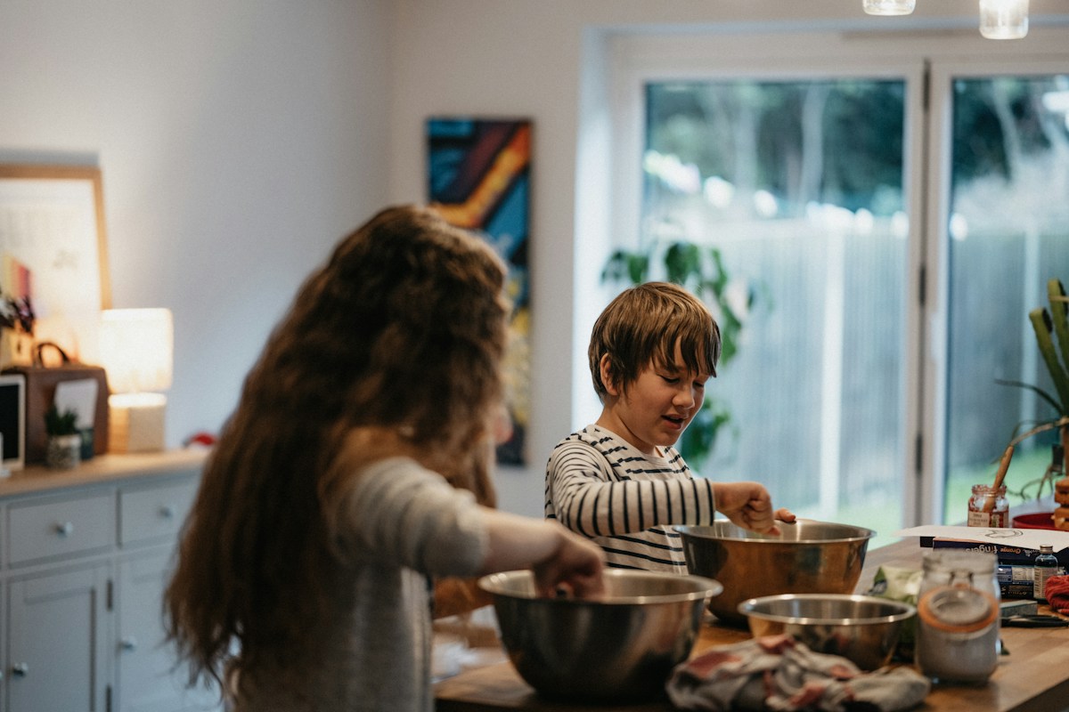Children baking together in a warm kitchen &mdash; a familiar scene at any Irish family gathering