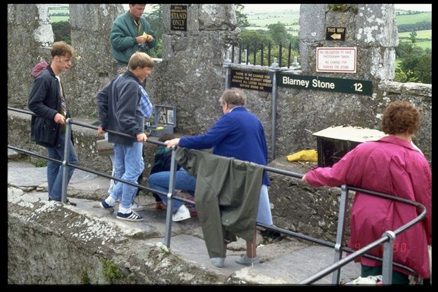 Visitors queuing on the parapet of Blarney Castle to kiss the Blarney Stone