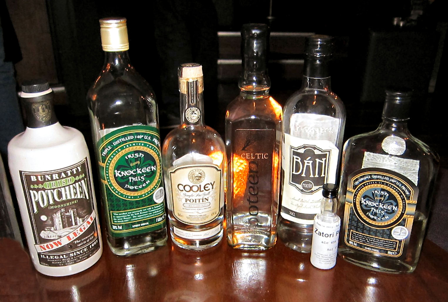 Bottles of legal Irish poitín on display in a poitín bar, including Bunratty Irish Potcheen, Knockeen Hills, Cooley and other craft brands