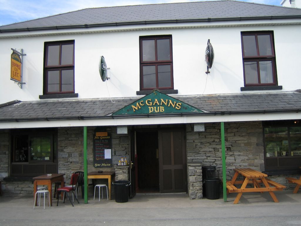 Exterior of McGann's Pub in Doolin, County Clare, with its green and gold signage above the entrance
