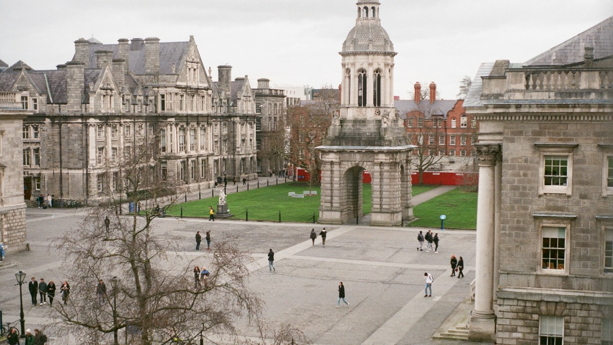 Students crossing Front Square at Trinity College Dublin, with the Campanile