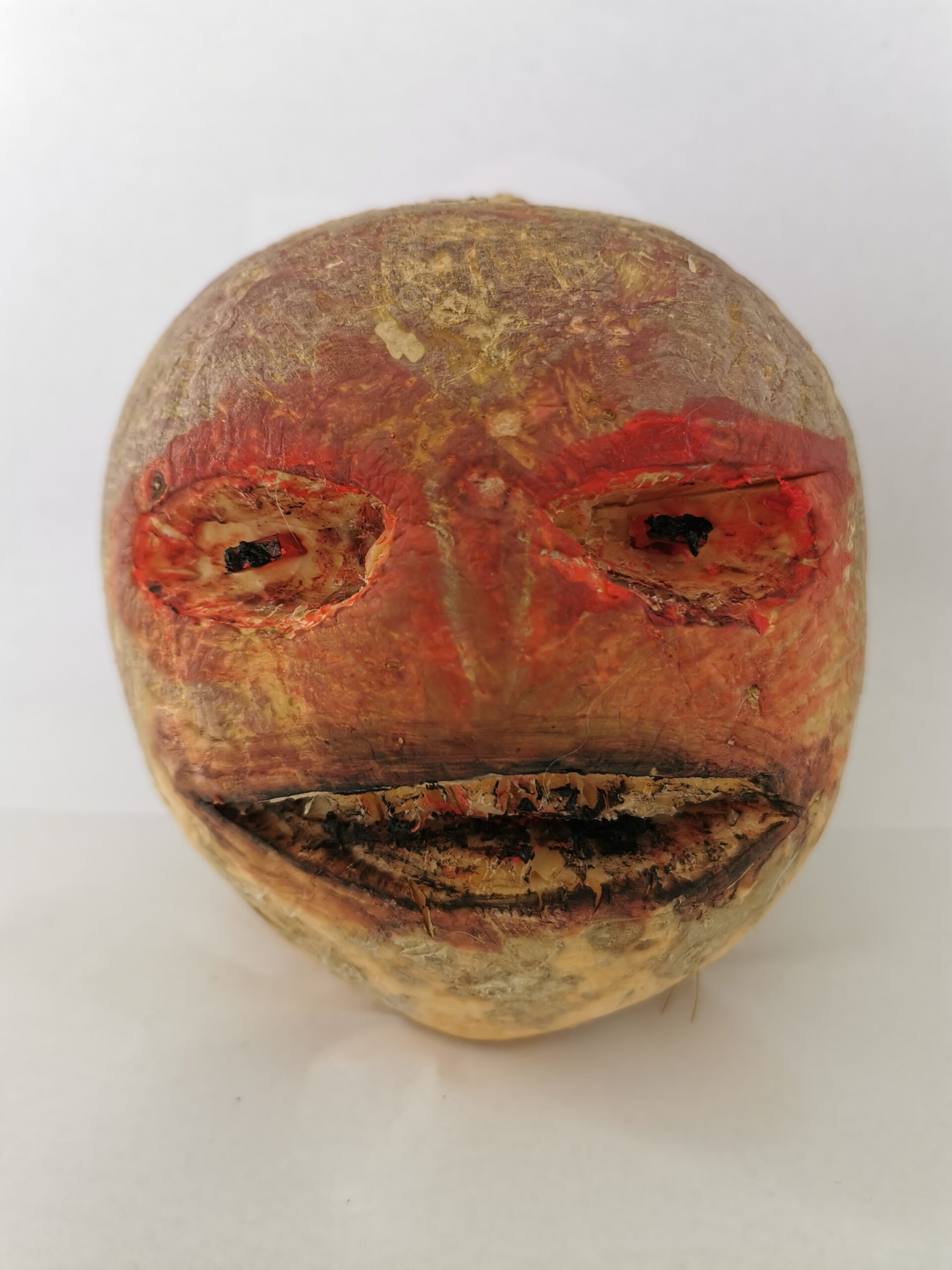 A traditional Irish Halloween turnip lantern, hand-carved with a crude grinning face, the folk-tale origin of the Stingy Jack jack-o'-lantern