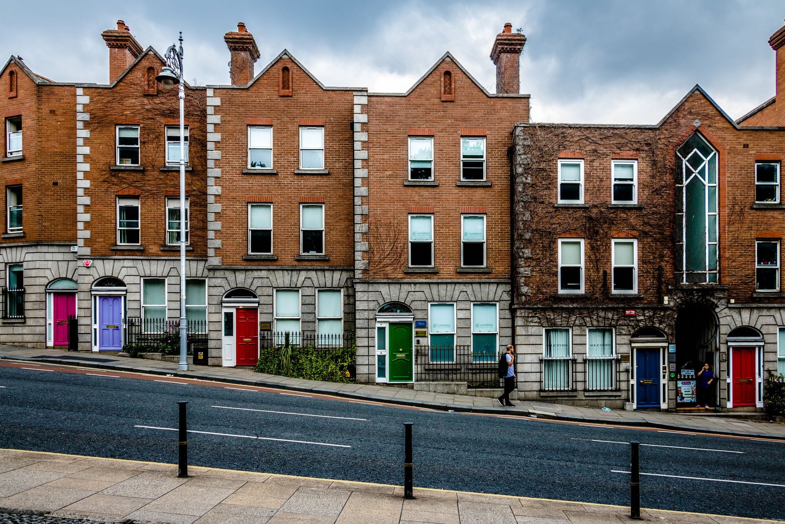 Red-brick Georgian houses with coloured doors on a Dublin street